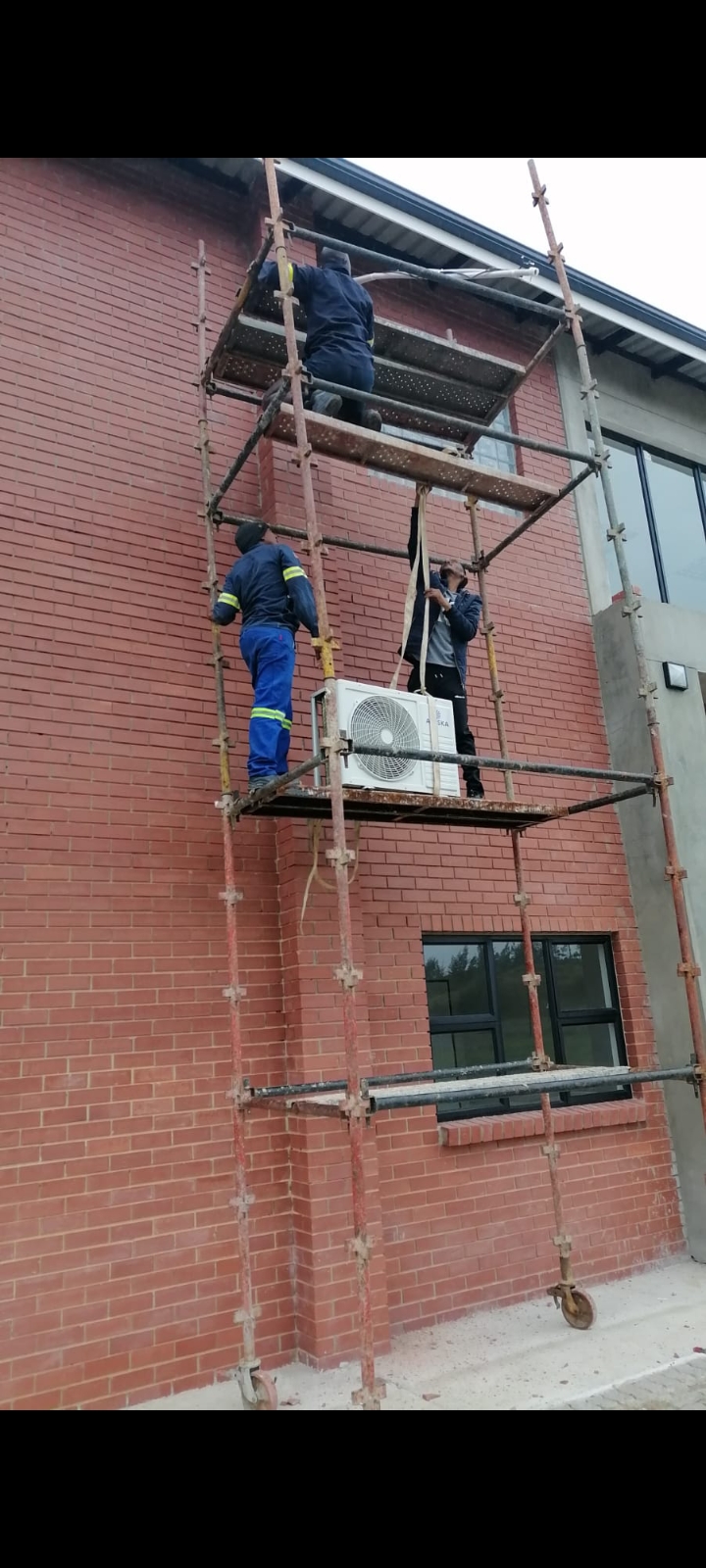 Air-conditioning outdoor unit installation on scaffolding